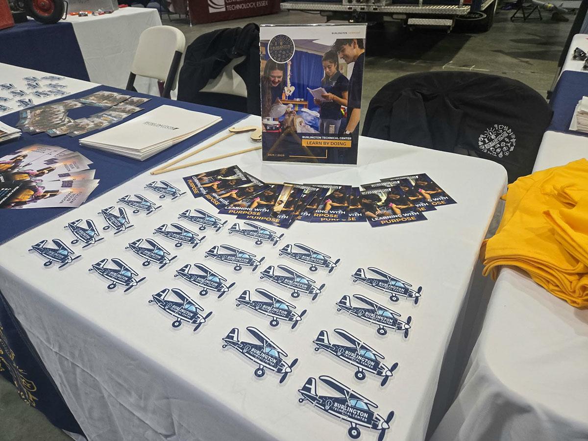 Burlington Technical Center literature and airplane-shaped printed pieces displayed on a table
